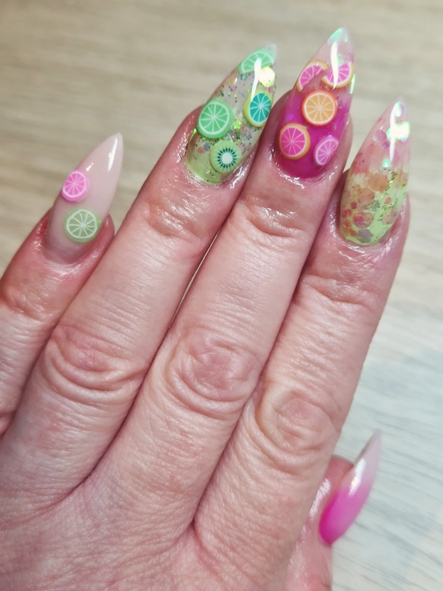 Pink and green sculpted nails with miniature citrus details